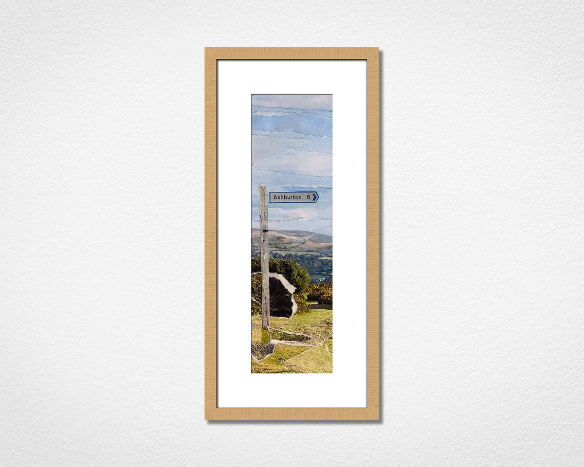 Framed collage artwork of a landscape of Dartmoor National Park with a signpost to the town of Ashburton