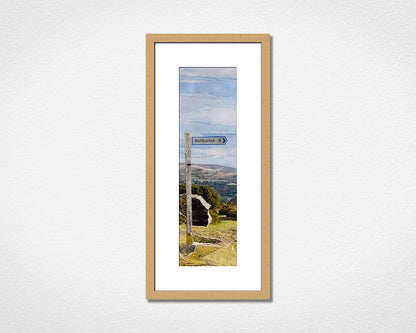 Framed collage artwork of a landscape of Dartmoor National Park with a signpost to the town of Ashburton
