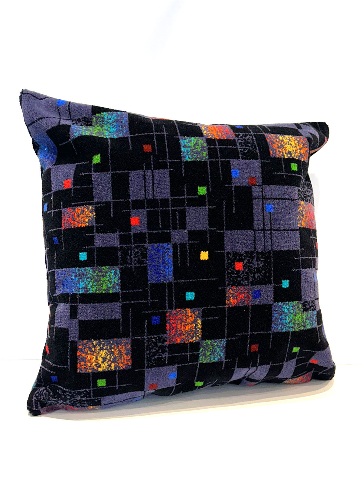 Black and grey moquette cushion with multicoloured squares