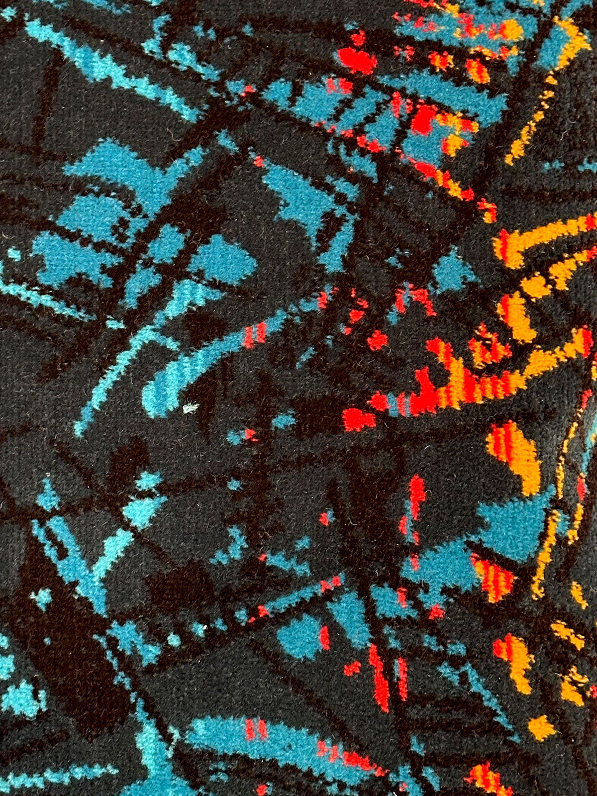 Moquette cushion detail - Blue and black with abstract pattern