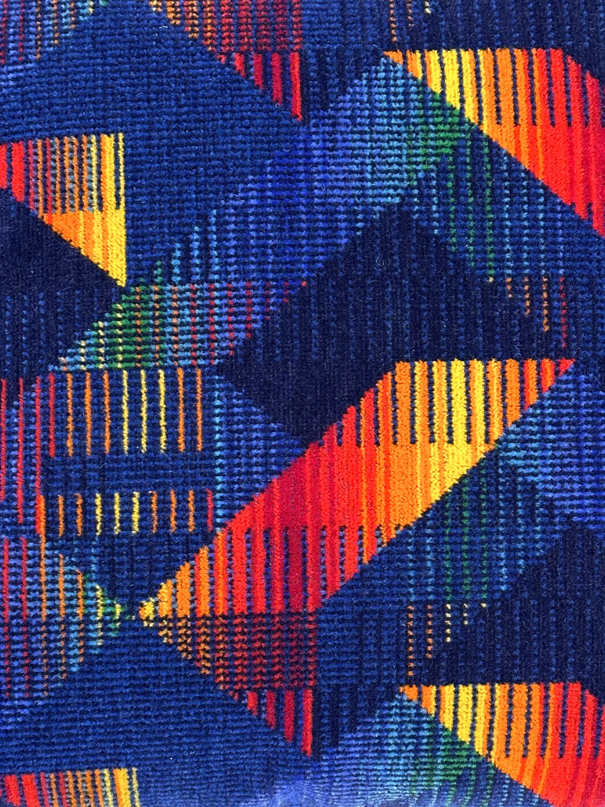 Blue moquette cushion with red and yellow geometrics