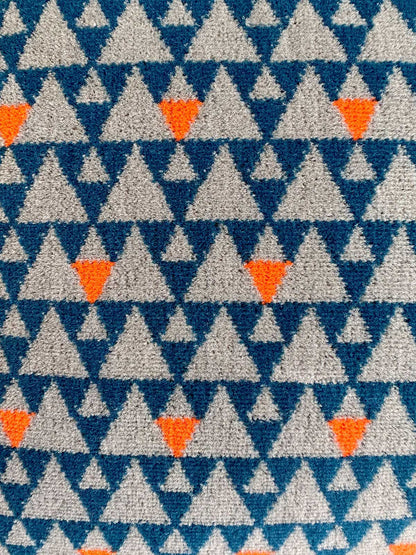 Grey and blue triangles cushion available from Jam