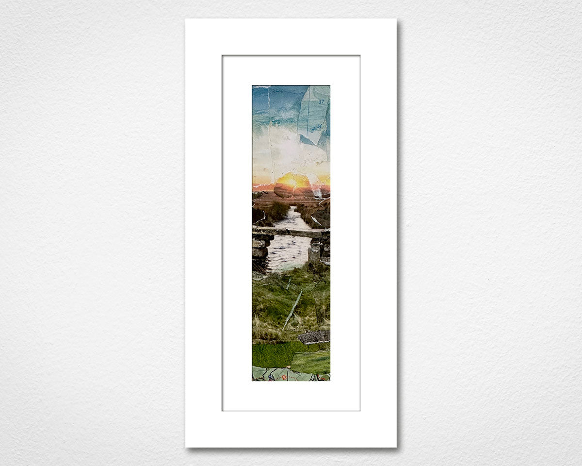 Framed collage of a scenic Dartmoor landscape with a sunset over water on a white wall.