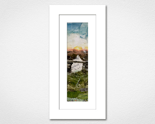 Framed collage of a scenic Dartmoor landscape with a sunset over water on a white wall.