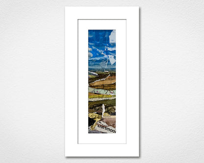 Framed artwork of a landscape with a mountain and text on a white wall