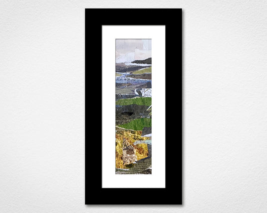 Framed artwork with a landscape scene on a white wall