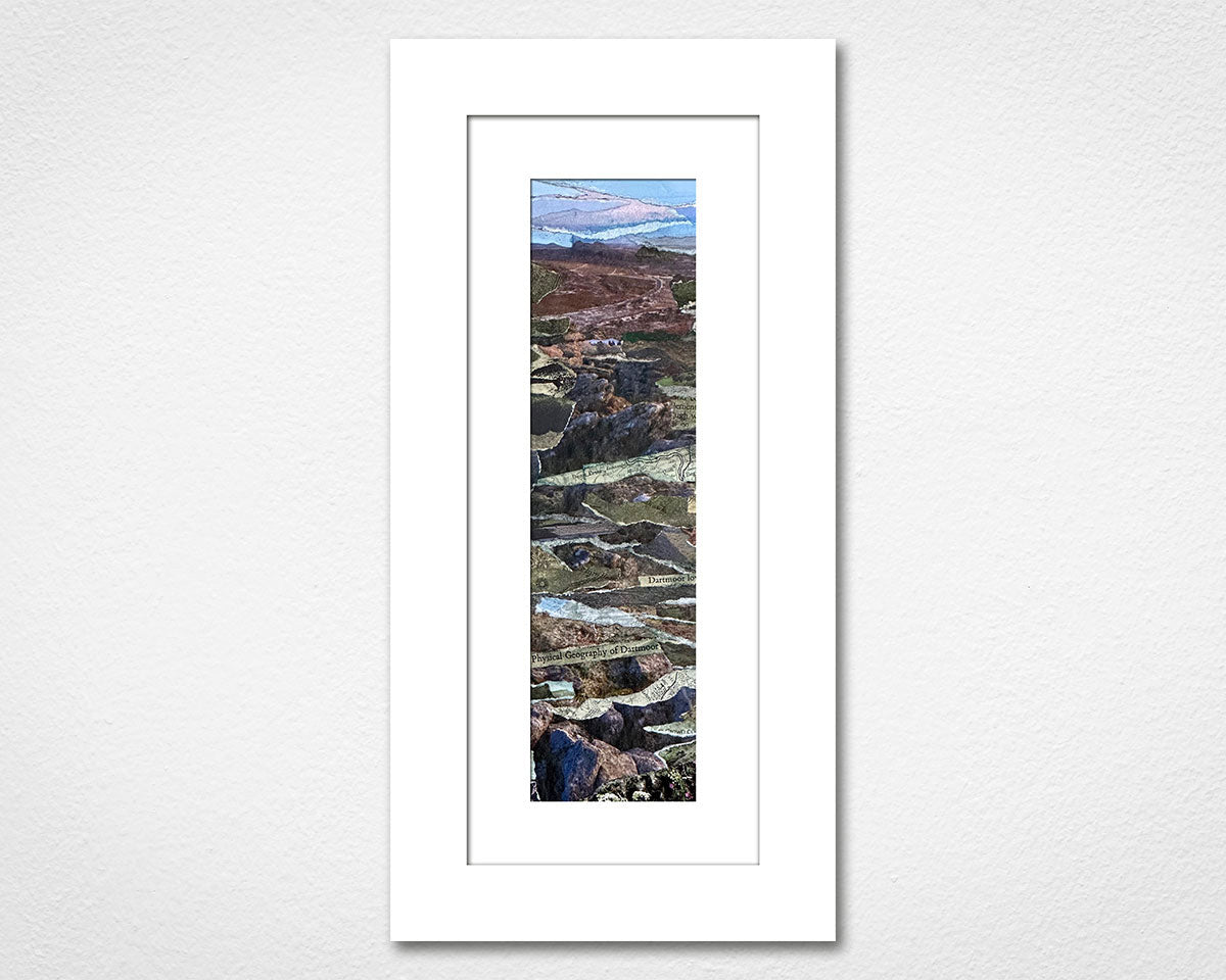 Framed artwork of a mountain landscape on a white wall