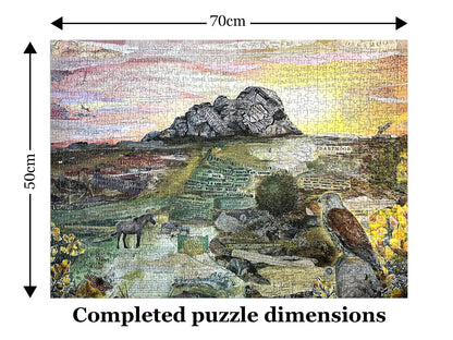 The completed Haytor – A Dartmoor Icon jigsaw puzzle overlaid with dimension arrows indicating 70 cm wide by 50 cm tall, with the text 'Completed puzzle dimensions' below.