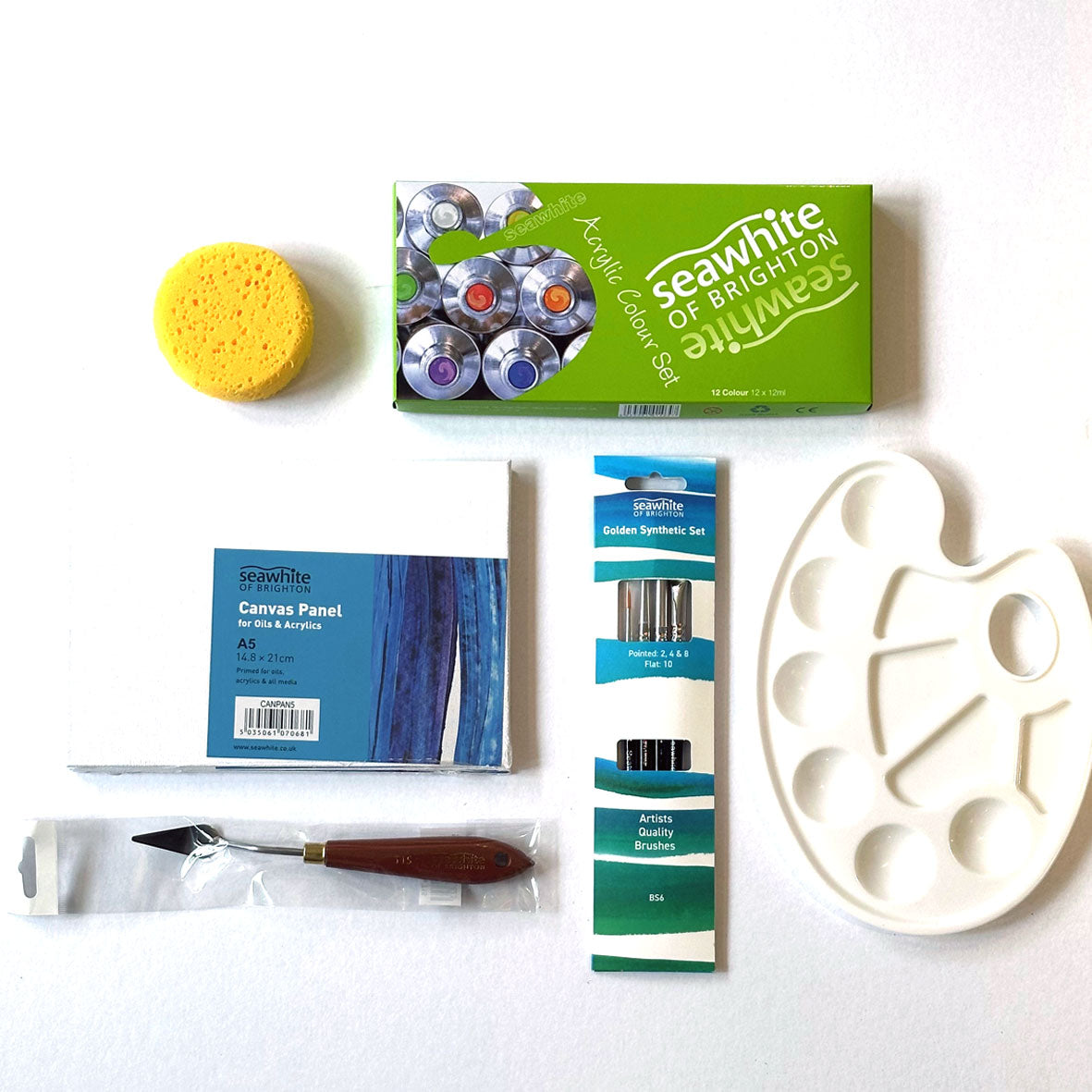 The Acrylic Kit Box containing art supplies including a sponge, paint tubes, a palette, and a canvas panel on a white background.