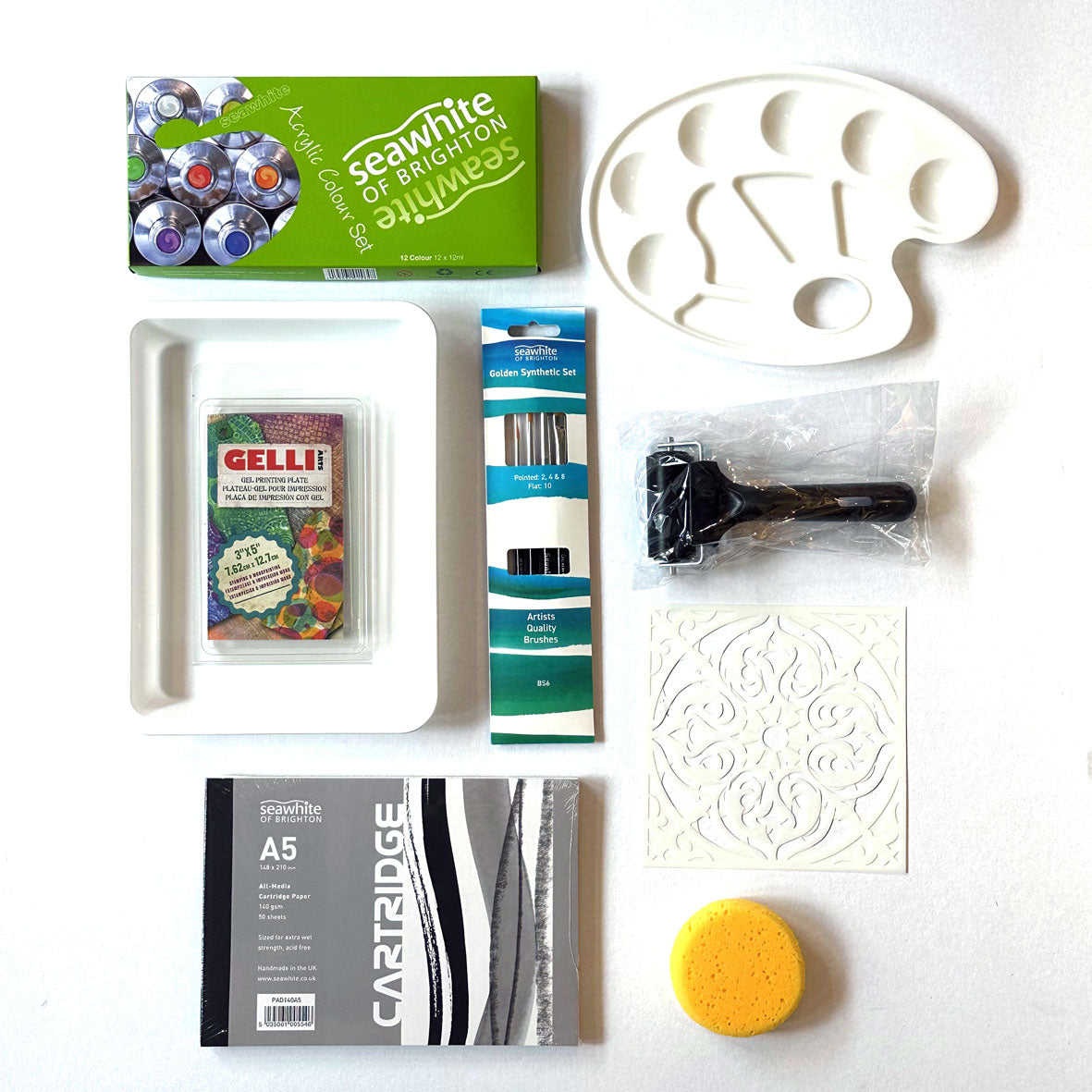 The Gel Plate Printing Kit Box containing a collection of art supplies including a gelli plate, paint palette, brushes, and other tools on a white background.